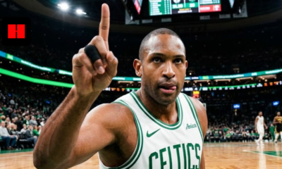 Boston Celtics forward Al Horford pointing his finger up during a game at TD Garden, wearing a white home jersey with green trim.