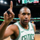 Boston Celtics forward Al Horford pointing his finger up during a game at TD Garden, wearing a white home jersey with green trim.