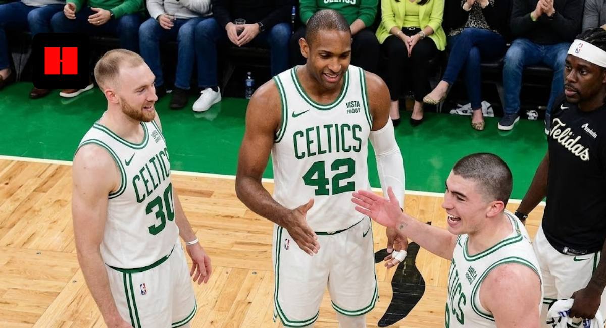 Boston Celtics veterans Al Horford, Payton Pritchard, and Sam Hauser sharing a moment on the court at TD Garden, illustrating Horford's leadership and the development of the Celtics' core rotation.