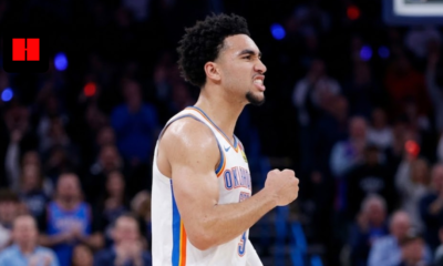 Philadelphia 76ers guard Jared McCain flexing and celebrating after a big play during an NBA game.