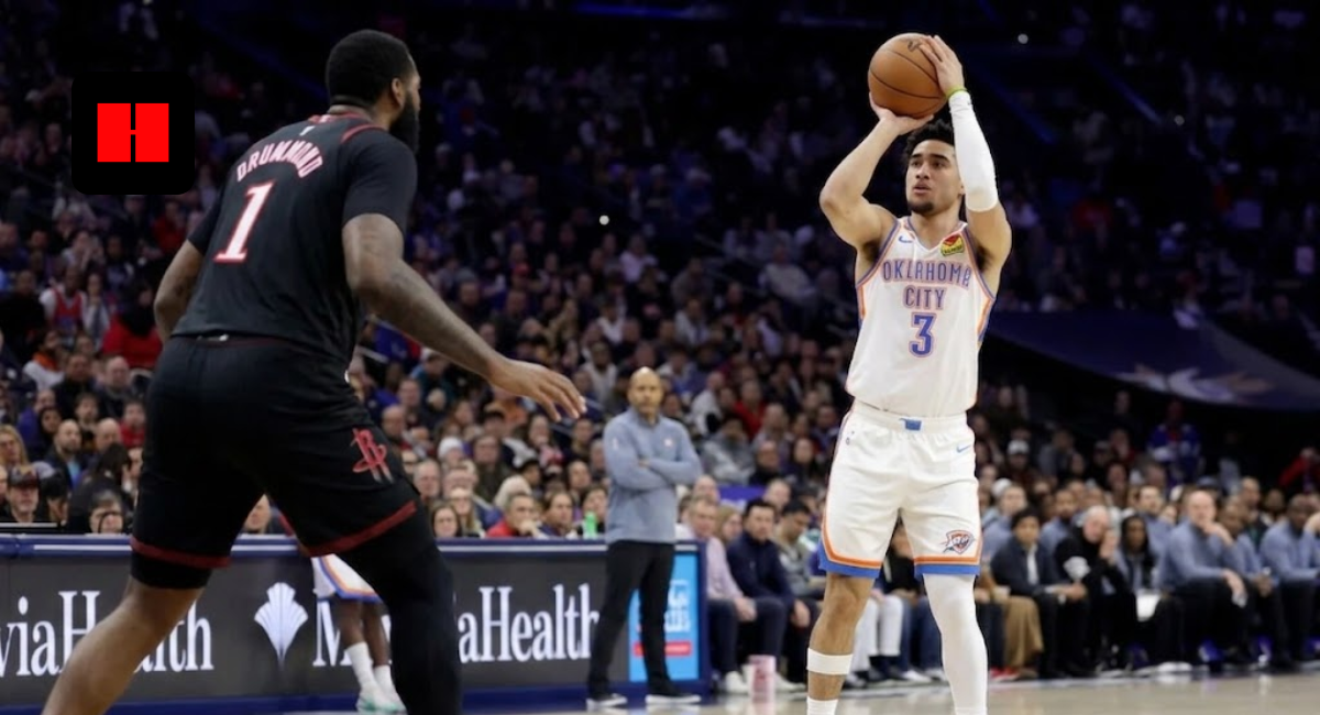 Jared McCain of the Philadelphia 76ers taking a jump shot over a defender during an NBA game.