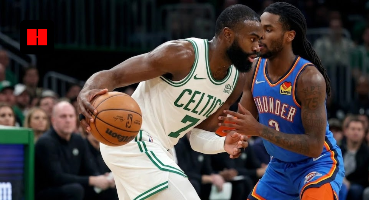 Jaylen Brown of the Boston Celtics protecting the basketball while being guarded by a defender from the Oklahoma City Thunder during a game.
