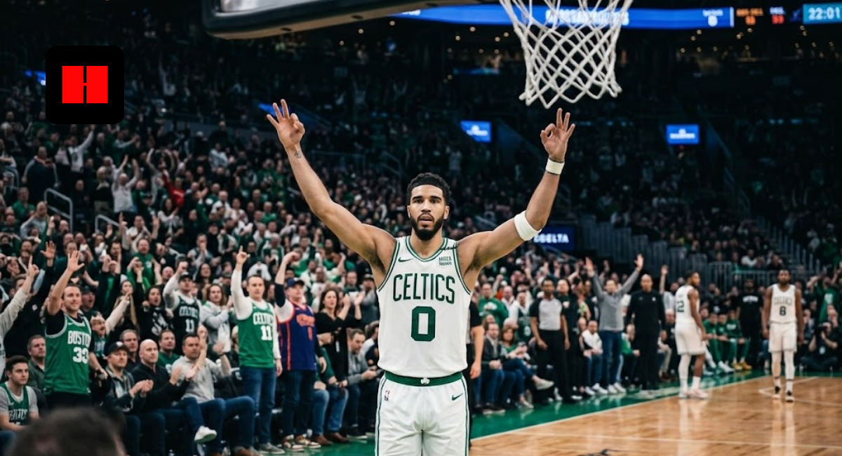 Jayson Tatum of the Boston Celtics wearing a white #0 jersey, raising his arms in celebration on the basketball court during a home game at TD Garden.