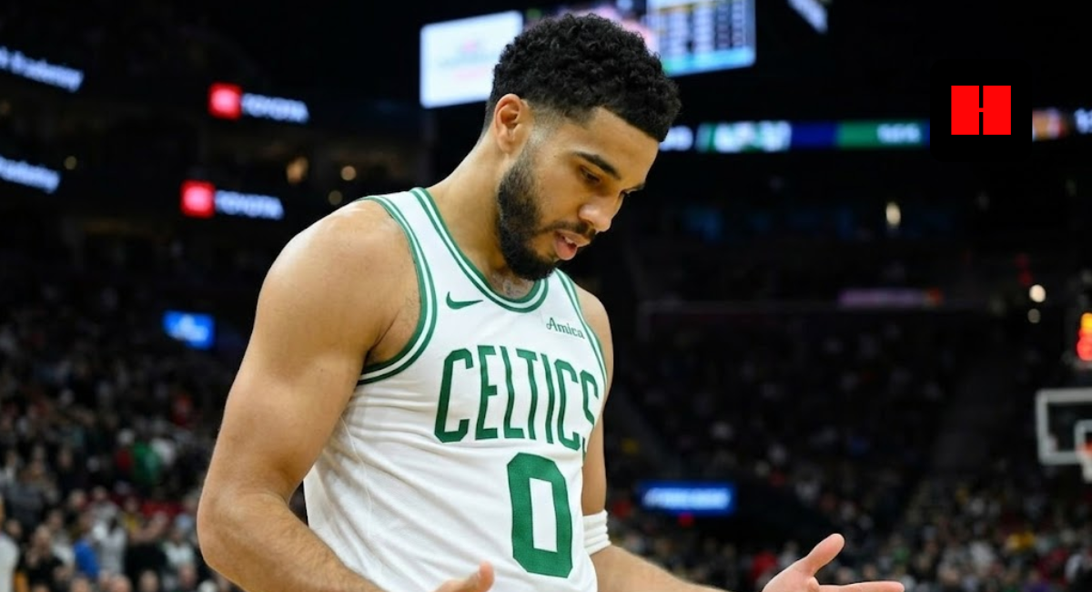 Jayson Tatum of the Boston Celtics wearing a white jersey with arms outstretched in frustration during an NBA game