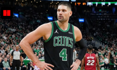 NBA center Nikola Vučević wearing a black Boston Celtics Statement Edition jersey with number 4, standing on the court during a game against the Miami Heat.