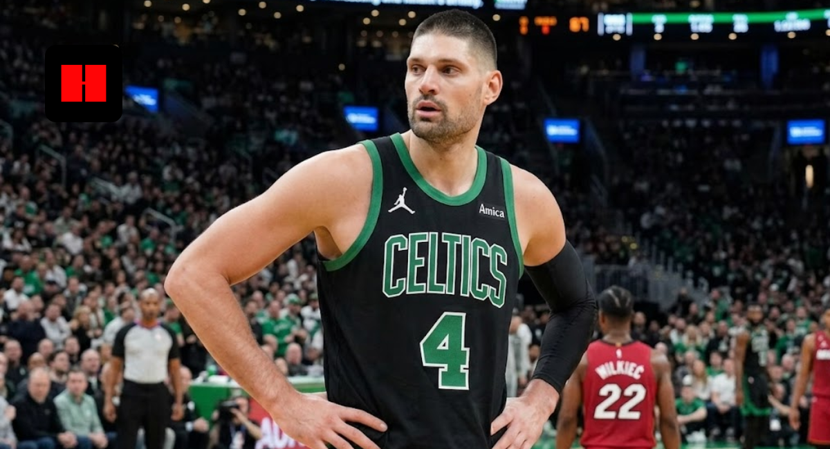 NBA center Nikola Vučević wearing a black Boston Celtics Statement Edition jersey with number 4, standing on the court during a game against the Miami Heat.