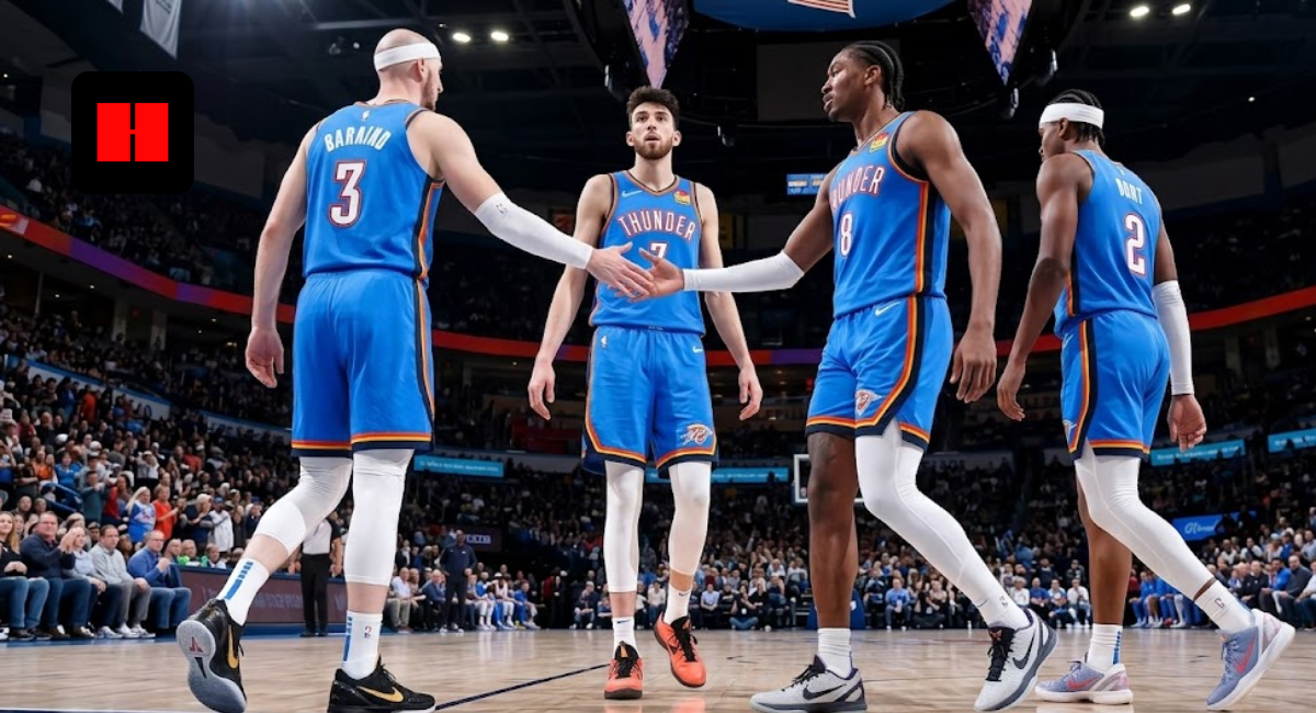 Low-angle shot of Oklahoma City Thunder basketball players in blue jerseys, featuring Chet Holmgren and Jalen Williams high-fiving during a game in a packed arena.