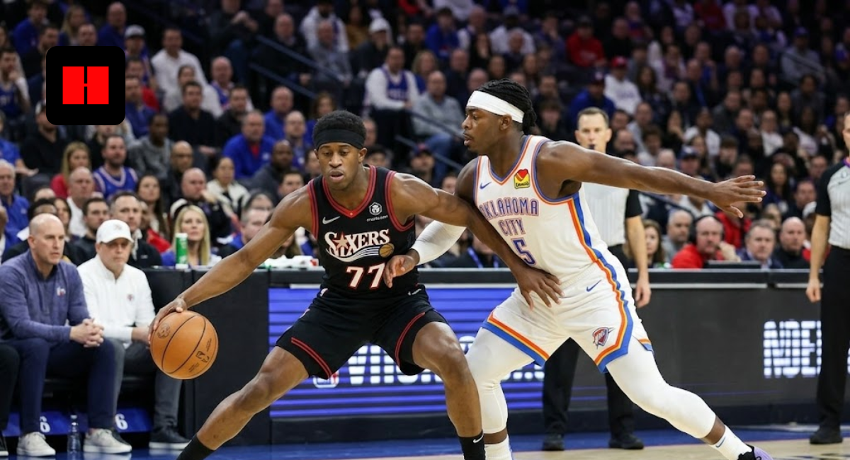 Philadelphia 76ers player in a black jersey #77 dribbling a basketball past an Oklahoma City Thunder defender in a white jersey #5 during an NBA game.