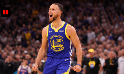 Stephen Curry roaring in Warriors uniform during high intensity NBA game action shot wide banner