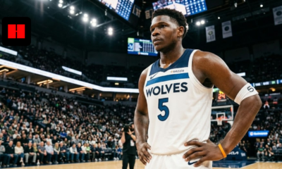 Anthony Edwards of the Minnesota Timberwolves standing on the court in a white Association Edition jersey, looking focused during a game.