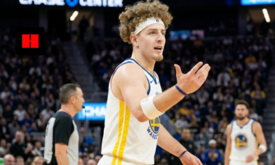 Brandin Podziemski of the Golden State Warriors standing on the court at Chase Center with his arm outstretched, looking toward a referee or teammate during a game.