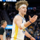 Brandin Podziemski of the Golden State Warriors standing on the court at Chase Center with his arm outstretched, looking toward a referee or teammate during a game.