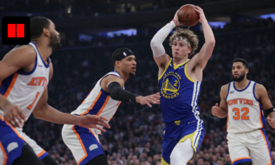 Brandin Podziemski of the Warriors looks to pass while surrounded by New York Knicks defenders during an NBA game in New York.