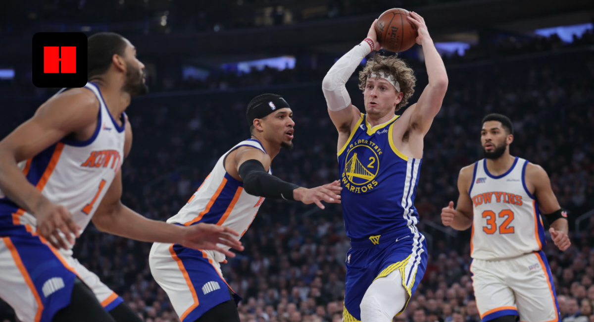 Brandin Podziemski of the Warriors looks to pass while surrounded by New York Knicks defenders during an NBA game in New York.