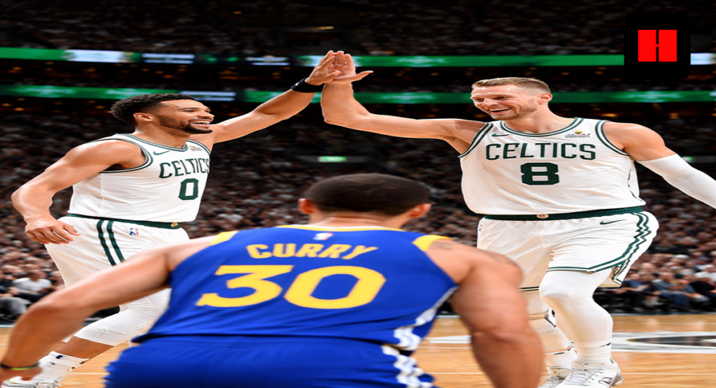 Jaylen Brown and Kristaps Porziņģis celebrate a high-five as Stephen Curry stands in the foreground, captured from a dramatic low camera angle during a Celtics vs Warriors game.