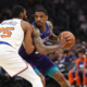 Charlotte Hornets player backing down New York Knicks defender during NBA basketball game action