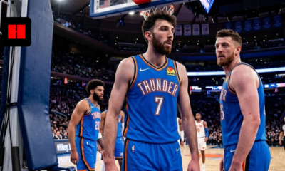 Chet Holmgren and Isaiah Hartenstein in Oklahoma City Thunder blue jerseys standing on a basketball court during an NBA game.