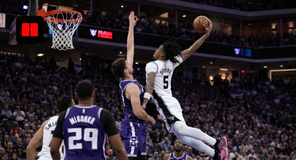 San Antonio Spurs guard Dejounte Murray elevates for one-handed dunk over Sacramento Kings defender during NBA game.
