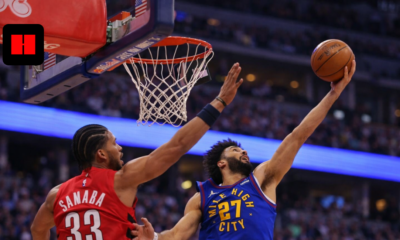 Denver Nuggets player attempting a right-handed layup while Toronto Raptors defender contests near the basket during an NBA game