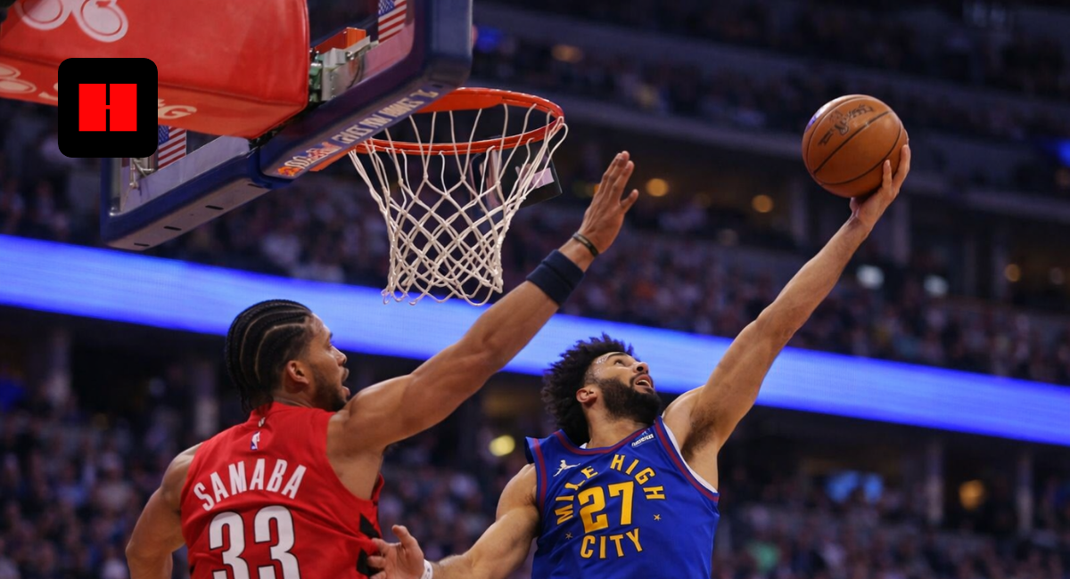 Denver Nuggets player attempting a right-handed layup while Toronto Raptors defender contests near the basket during an NBA game