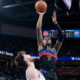Detroit Pistons player number 7 performing a high-release jump shot over an Oklahoma City Thunder defender during an NBA game.