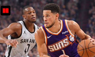Devin Booker dribbling the basketball against San Antonio Spurs defender during an NBA game in high resolution.