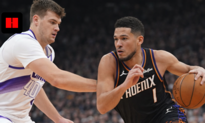 Devin Booker dribbling the basketball against Los Angeles Clippers defender during NBA game