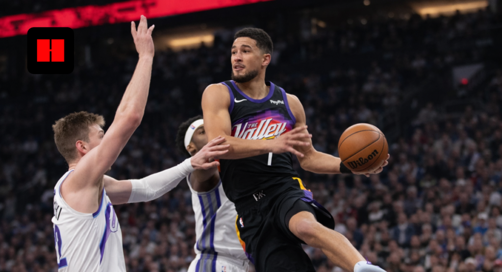 Devin Booker driving to the basket against Sacramento Kings defenders during an NBA game