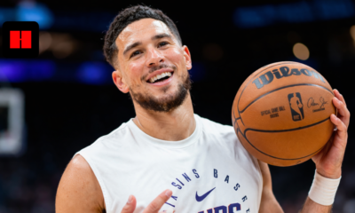 Devin Booker holding basketball during Phoenix Suns warmup in NBA arena UHD image