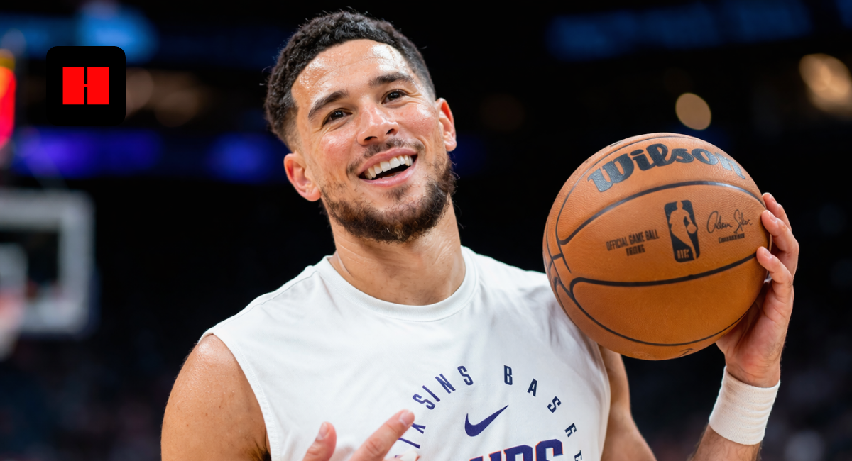 Devin Booker holding basketball during Phoenix Suns warmup in NBA arena UHD image