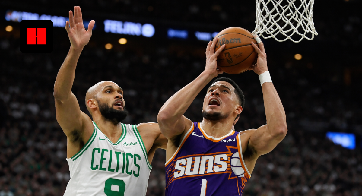 Phoenix Suns' Devin Booker going up for a layup against Jayson Tatum of the Boston Celtics at TD Garden.