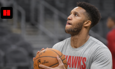 Former NBA player and Celtics coach Evan Turner practicing a jump shot in an Atlanta Hawks long-sleeve shirt during a pre-game warmup.
