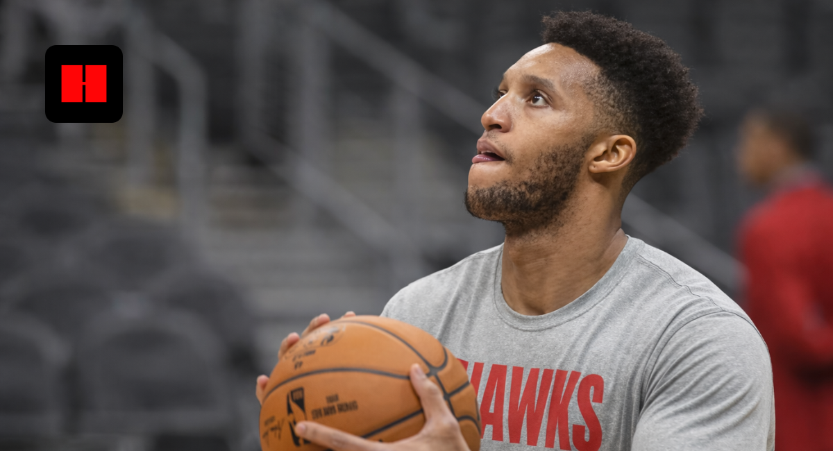 Former NBA player and Celtics coach Evan Turner practicing a jump shot in an Atlanta Hawks long-sleeve shirt during a pre-game warmup.
