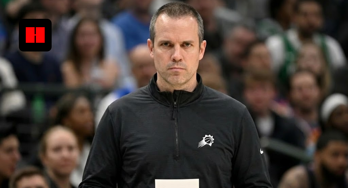 Frank Vogel, head coach of the Phoenix Suns, standing on the sidelines holding a play card during an NBA game.