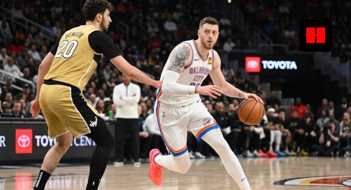 Oklahoma City Thunder's Isaiah Hartenstein driving to the hoop against a Washington Wizards defender in a gold and black jersey during an NBA game.