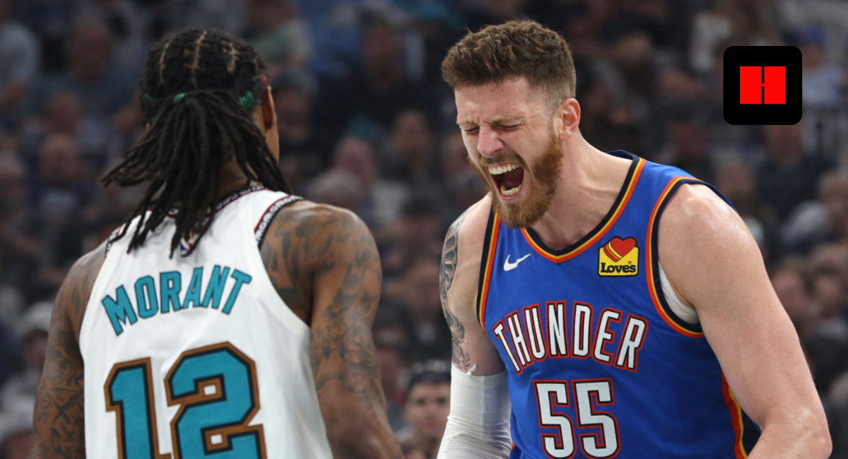 Oklahoma City Thunder center Isaiah Hartenstein yelling in celebration while facing Ja Morant of the Memphis Grizzlies during an NBA game.