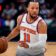 New York Knicks point guard Jalen Brunson (11) bringing the ball up the court at Madison Square Garden, wearing the home white Association Edition jersey with a focused expression during a 2026 regular season game.