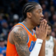Jalen Williams of the Oklahoma City Thunder on the basketball court, viewed from a side profile with hands held to his face in an intense, prayer-like pose during a game.