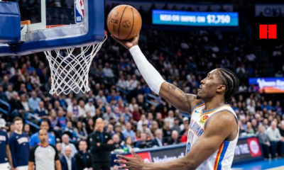 Oklahoma City Thunder forward Jalen Williams performing a finger-roll layup during an NBA game, side profile view.