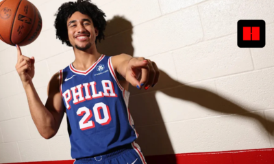 Jared McCain in Philadelphia 76ers jersey spins basketball on finger during media day photo shoot