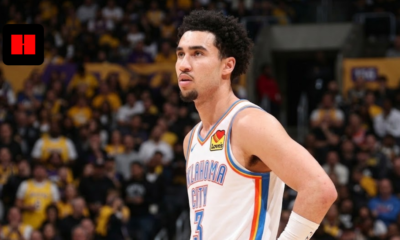 A close-up portrait photograph of Oklahoma City Thunder player Jared Mccain looking left during an NBA game, with his hand on his hip and a blurred crowd wearing yellow shirts in the background.