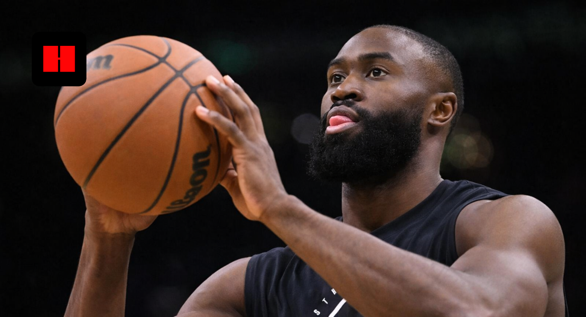 Jaylen Brown preparing to shoot a basketball during Boston Celtics practice with focused expression and blurred background.