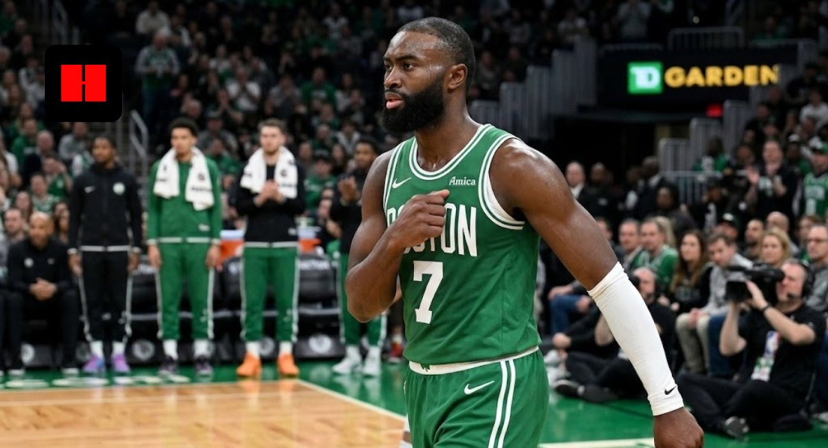 Jaylen Brown of the Boston Celtics wearing a green jersey with number 7, walking on the court at TD Garden during an NBA game.