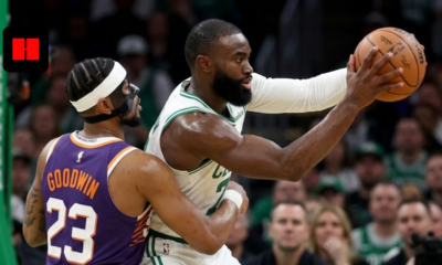 Boston Celtics forward Jaylen Brown protects the basketball while being defended by Phoenix Suns guard Jordan Goodwin during an NBA game.