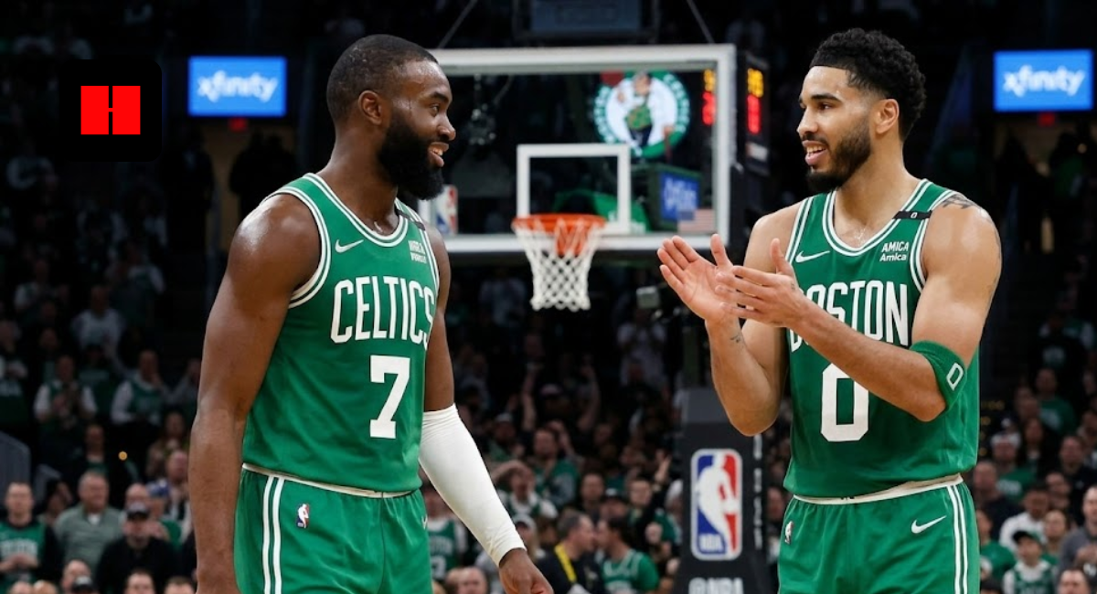 Boston Celtics stars Jaylen Brown (7) and Jayson Tatum (0) sharing a high five on the court during an NBA game.