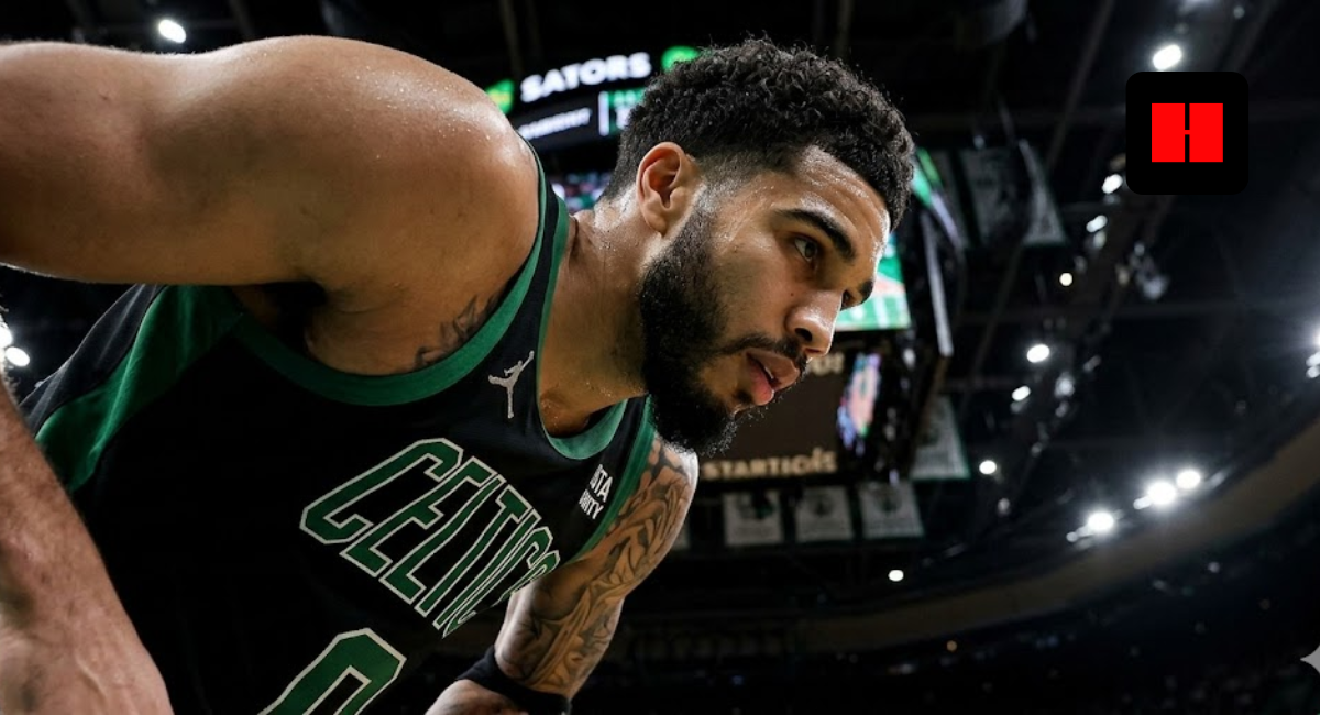 Close-up side profile of Jayson Tatum in a black Boston Celtics jersey, looking focused during a game break at TD Garden.
