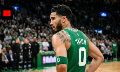 Jayson Tatum in a green Boston Celtics jersey with number 0, viewed from a back-side angle on the basketball court.