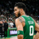 Jayson Tatum in a green Boston Celtics jersey with number 0, viewed from a back-side angle on the basketball court.