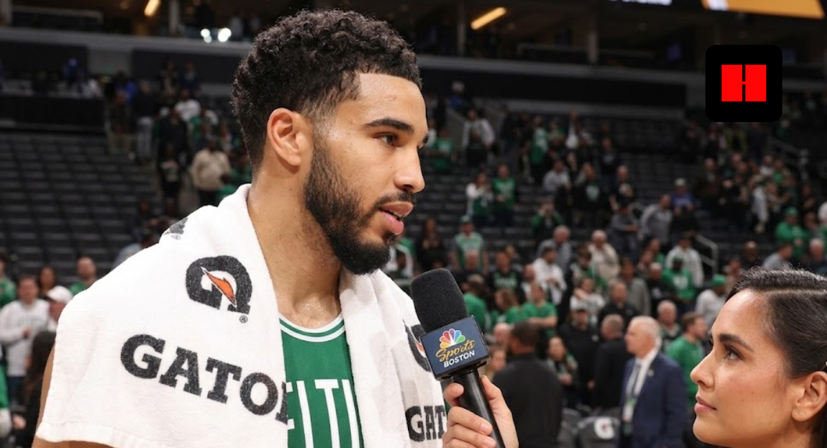Boston Celtics forward Jayson Tatum wearing a Gatorade towel during a post-game sideline interview with an NBC Sports Boston reporter.