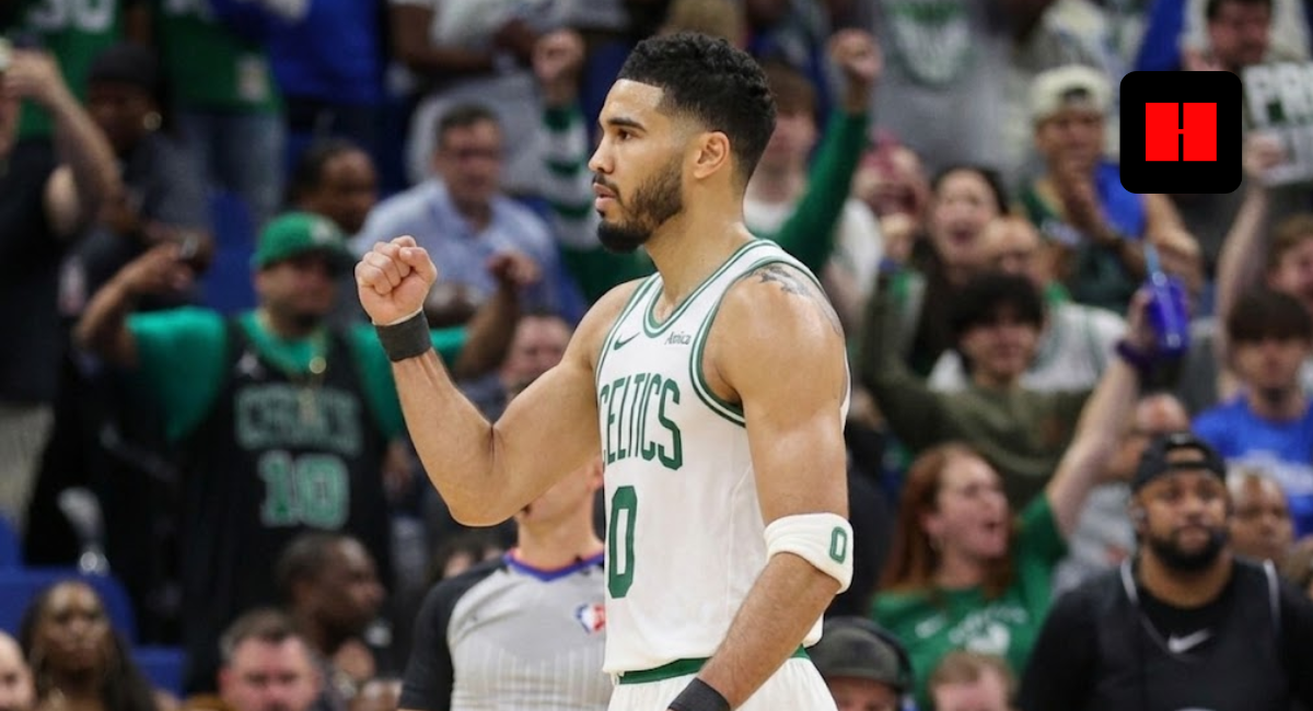 Jayson Tatum of the Boston Celtics celebrating on the court, viewed from a side angle in his white home jersey.
